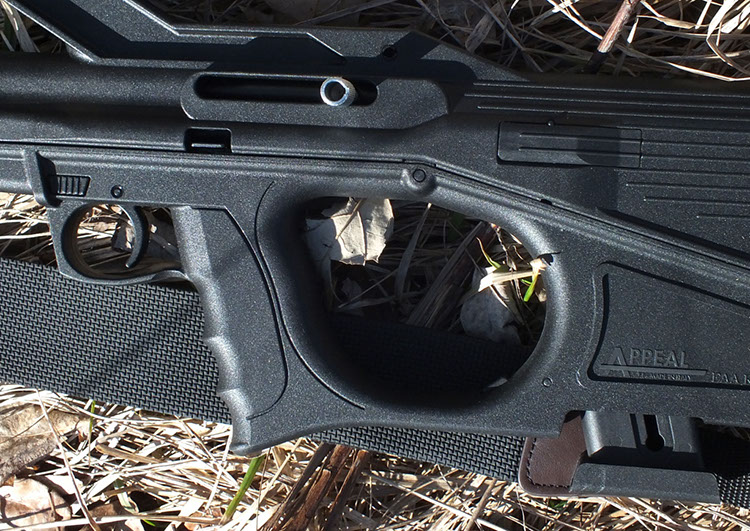 Closeup shows bolt lock release below charging handle slot, with ejection port cover behind. Tanfoglio Appeal Rimfire Rifle.