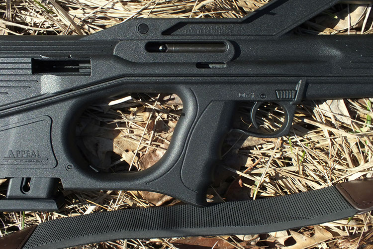 Partially inserted magazine with ejection port above, charging handle slot to right above grip and safety ahead of trigger. Tanfoglio Appeal Rimfire Rifle.