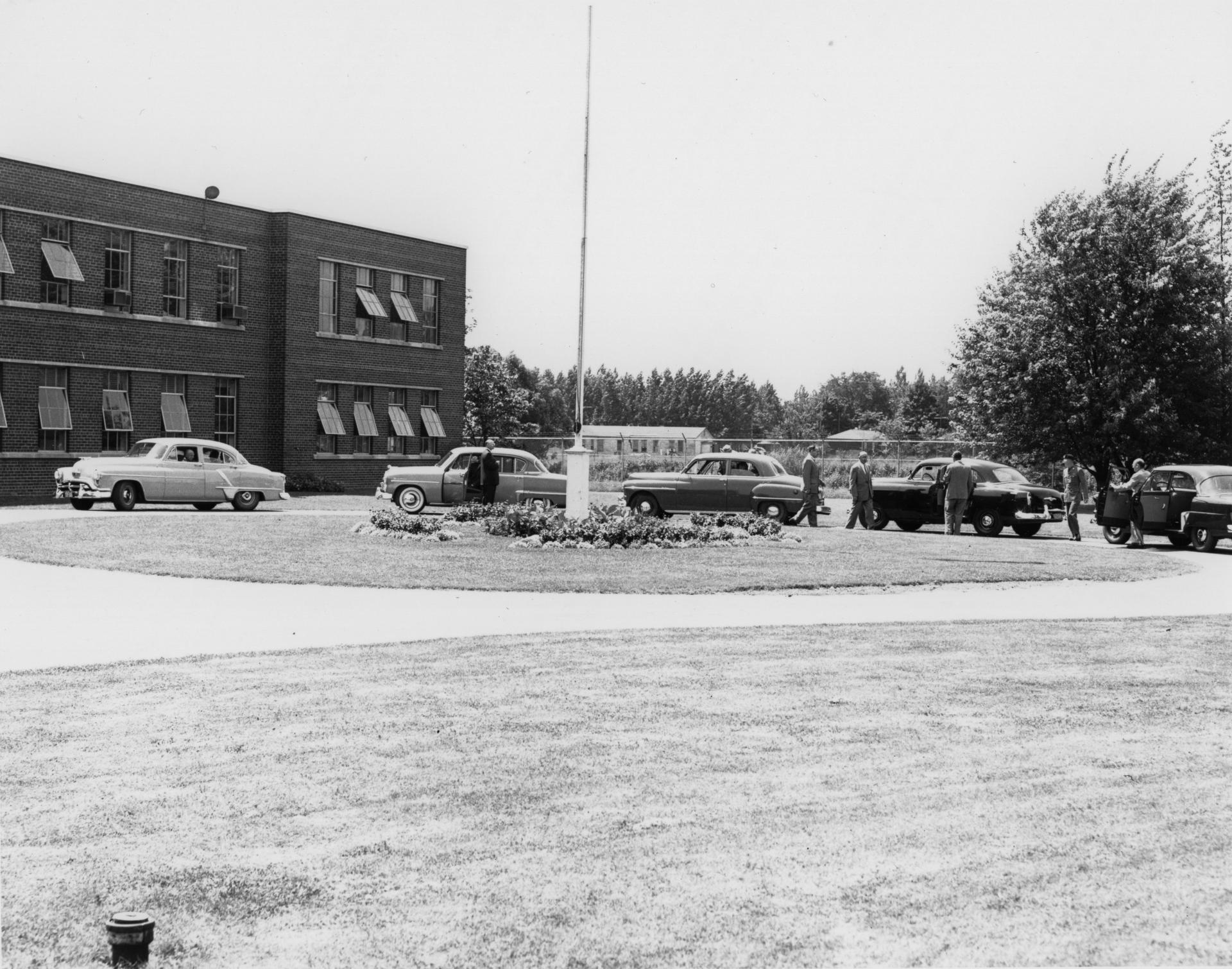 Cars parked outside Canadian Arsenals Limited's plant in the 50s.